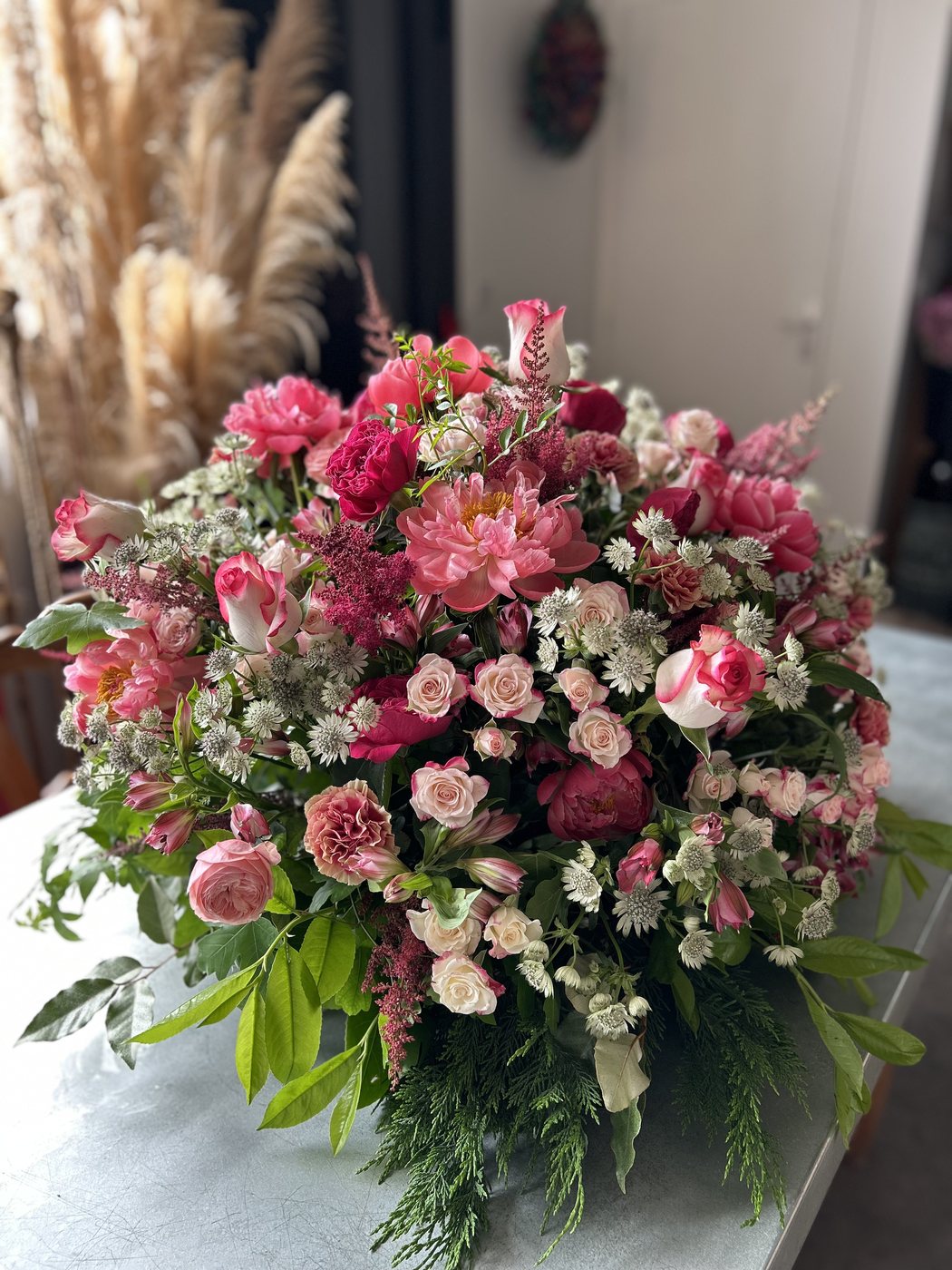 Large arrangement of pink roses and blooms