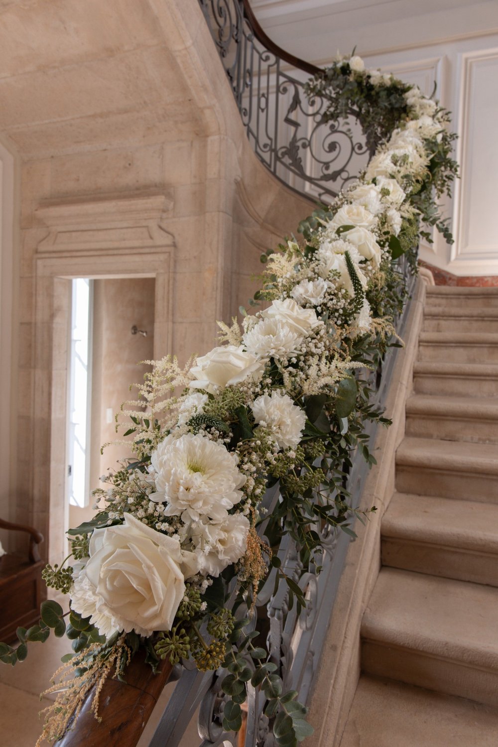 Château staircase banister dressed with white flowers and eucalyptus