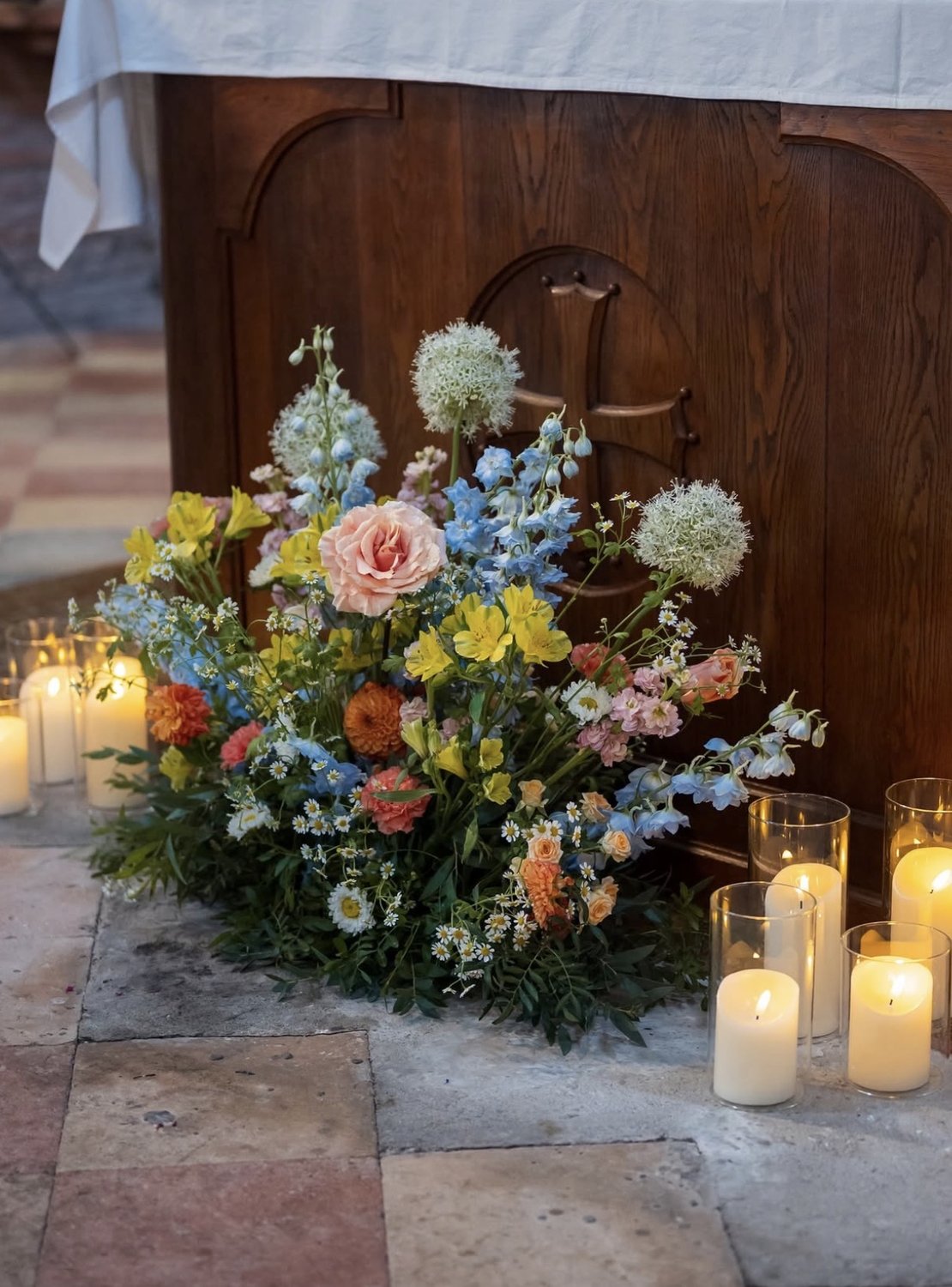 Pastel altar floral arrangement with candles